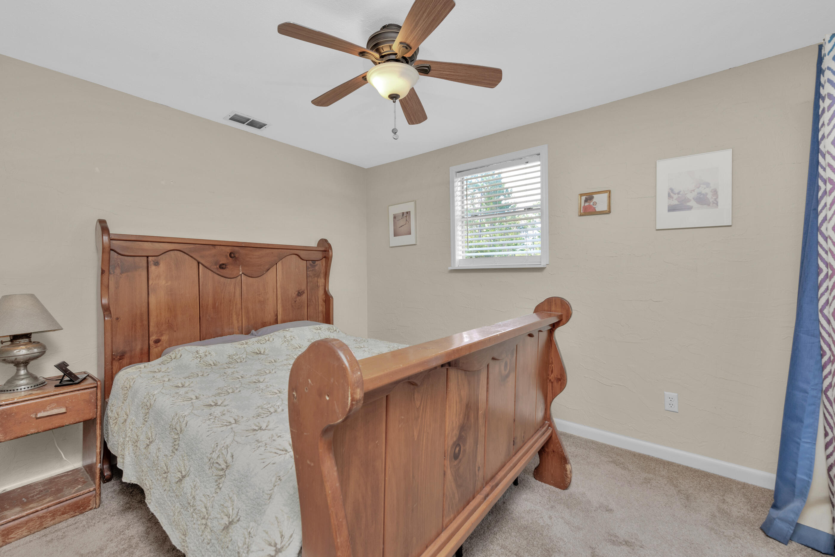193 L Street Santa Rosa Beach, FL 32459 - Photo 13 of 24 a bedroom with a bed and a chandelier