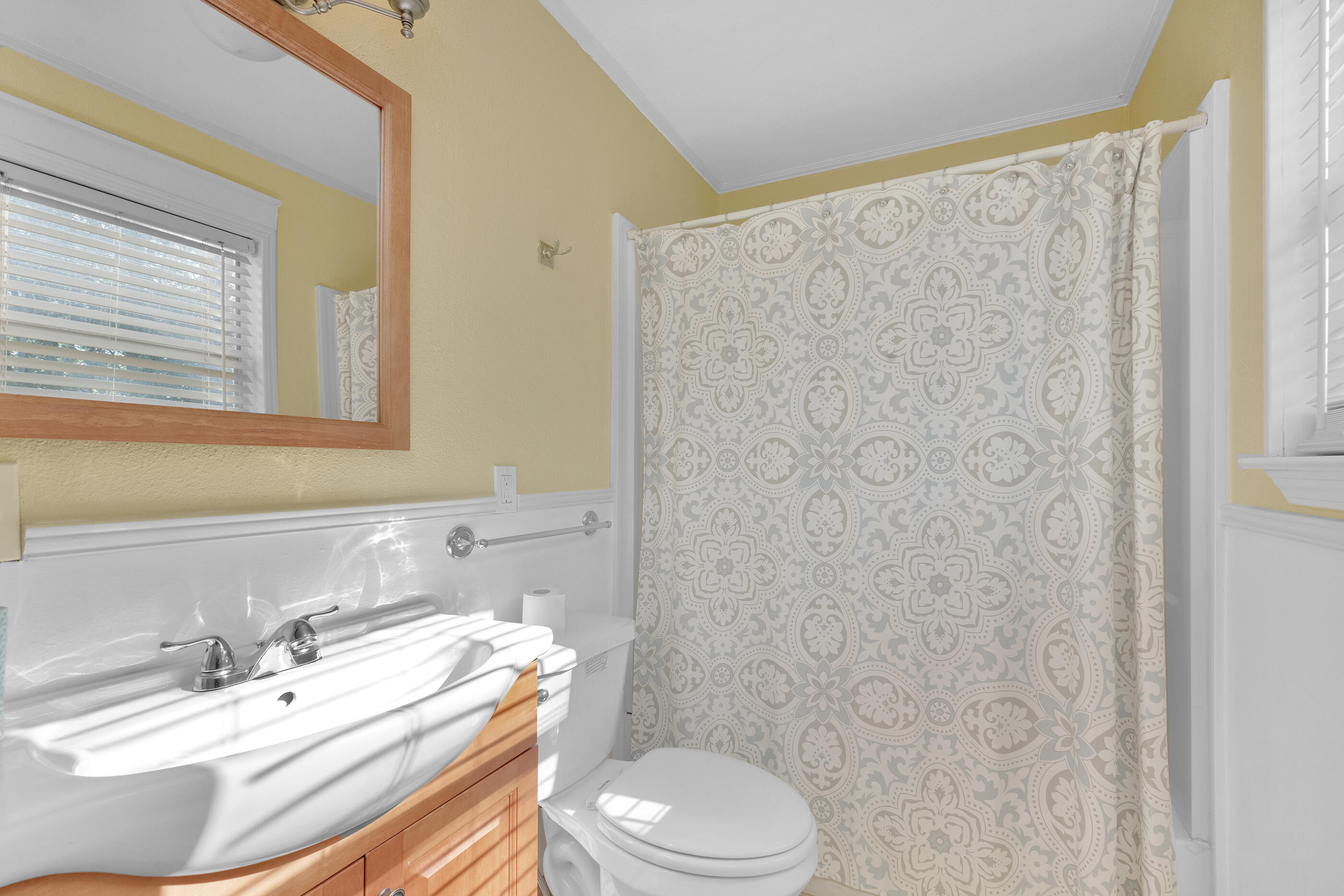 193 L Street Santa Rosa Beach, FL 32459 - Photo 19 of 24 a bathroom with a sink a toilet and a mirror
