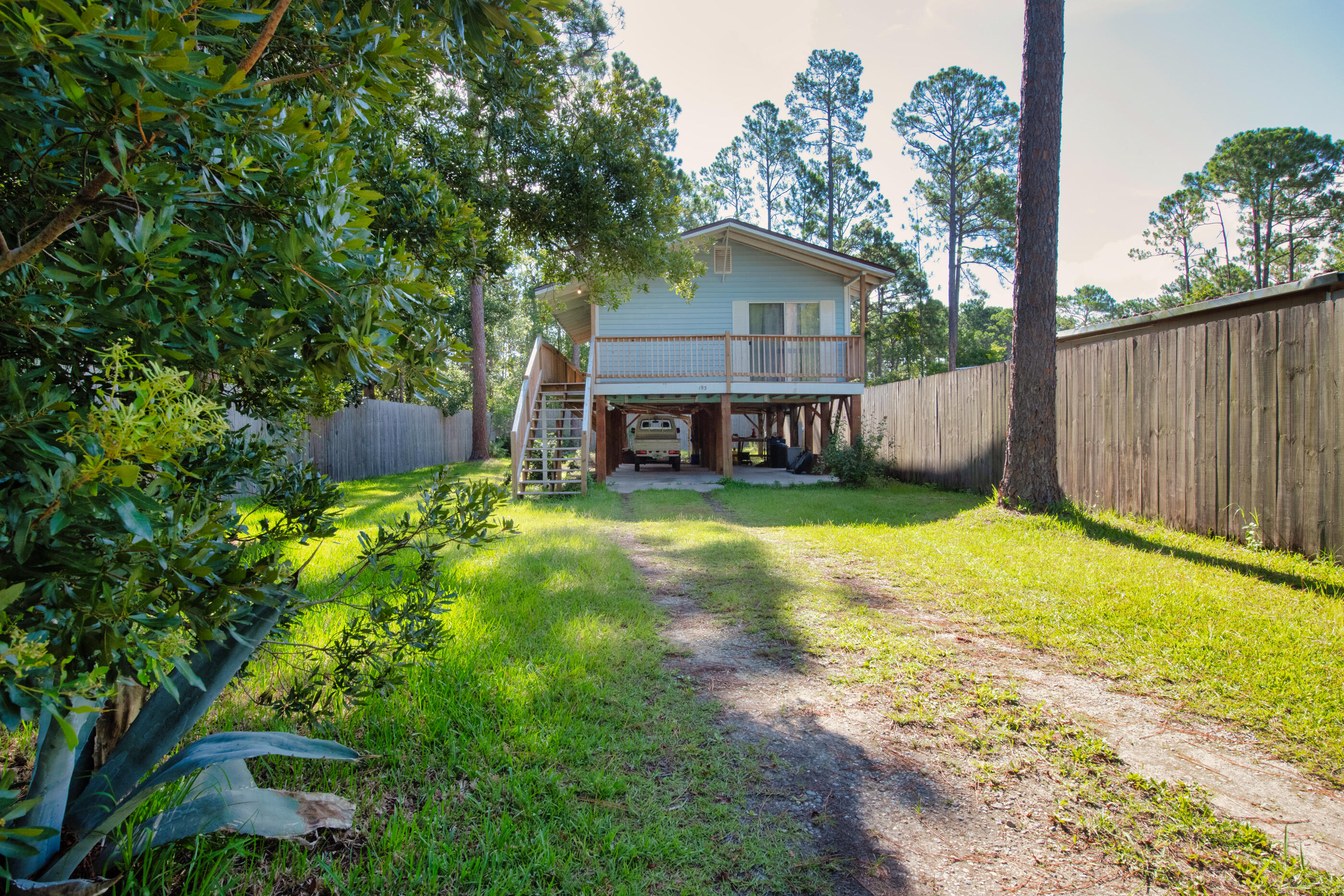 193 L Street Santa Rosa Beach, FL 32459 - Photo 22 of 24 a view of a house with a yard
