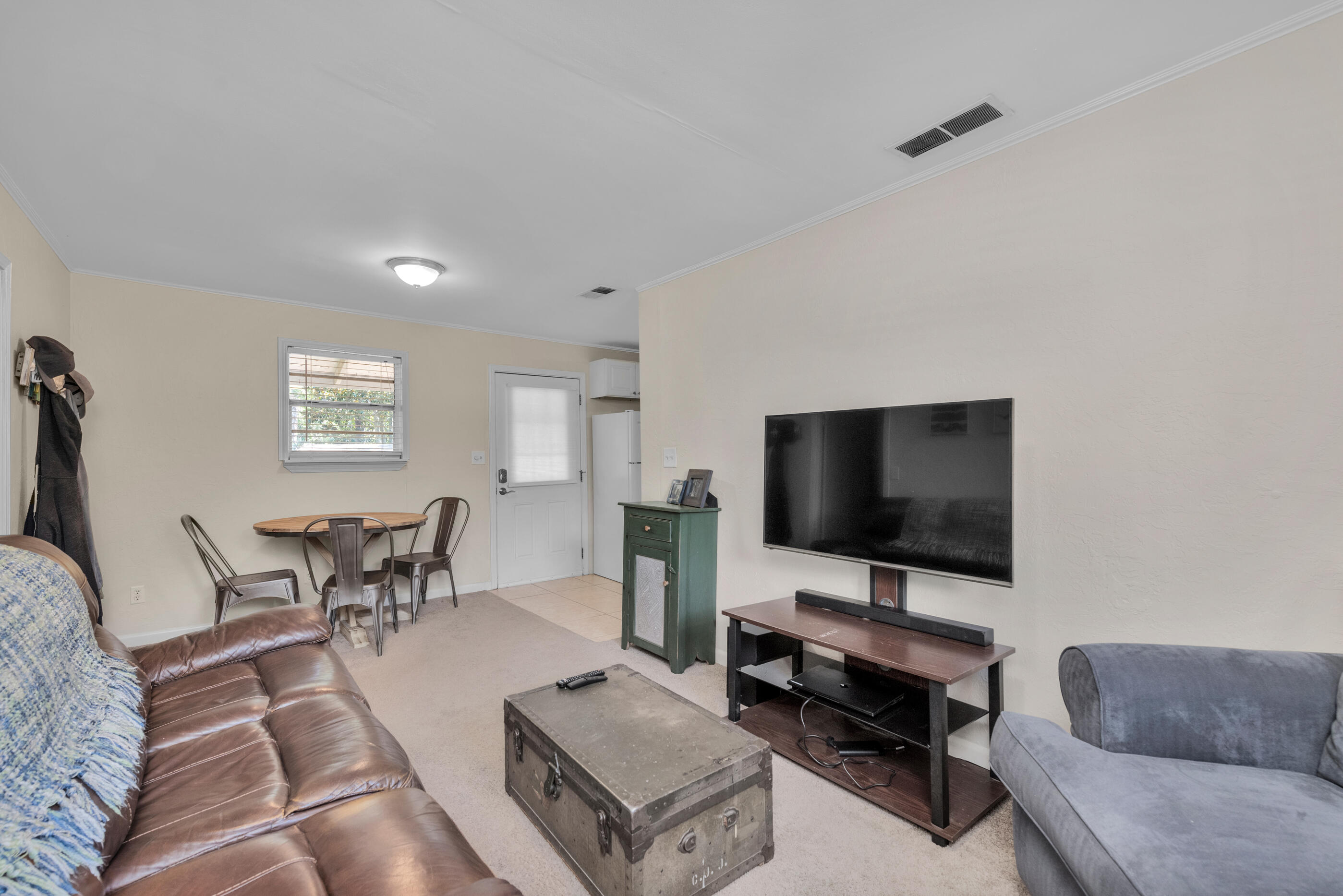193 L Street Santa Rosa Beach, FL 32459 - Photo 6 of 24 a living room with furniture and a flat screen tv