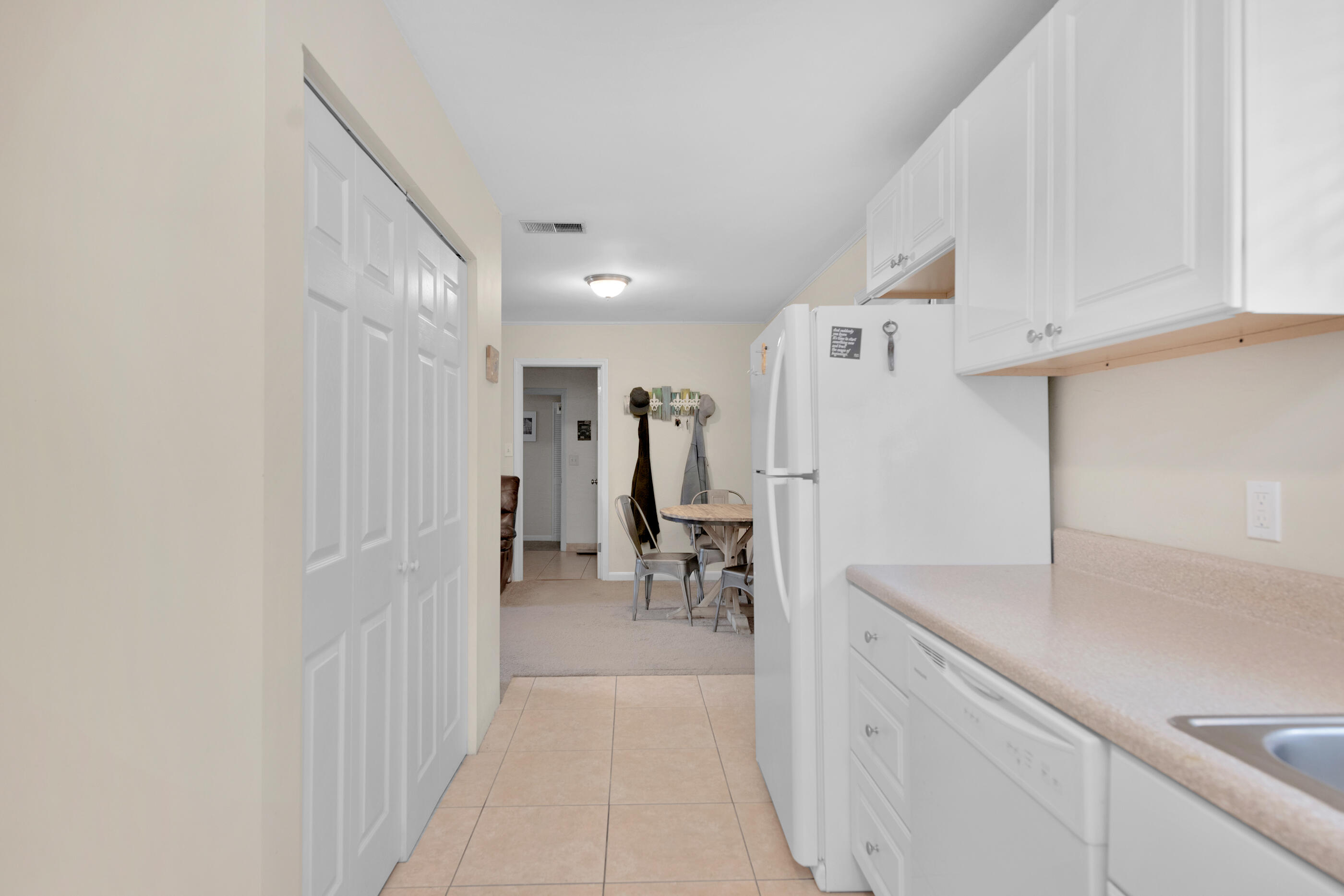 193 L Street Santa Rosa Beach, FL 32459 - Photo 8 of 24 a hallway with white cabinets and wooden floor