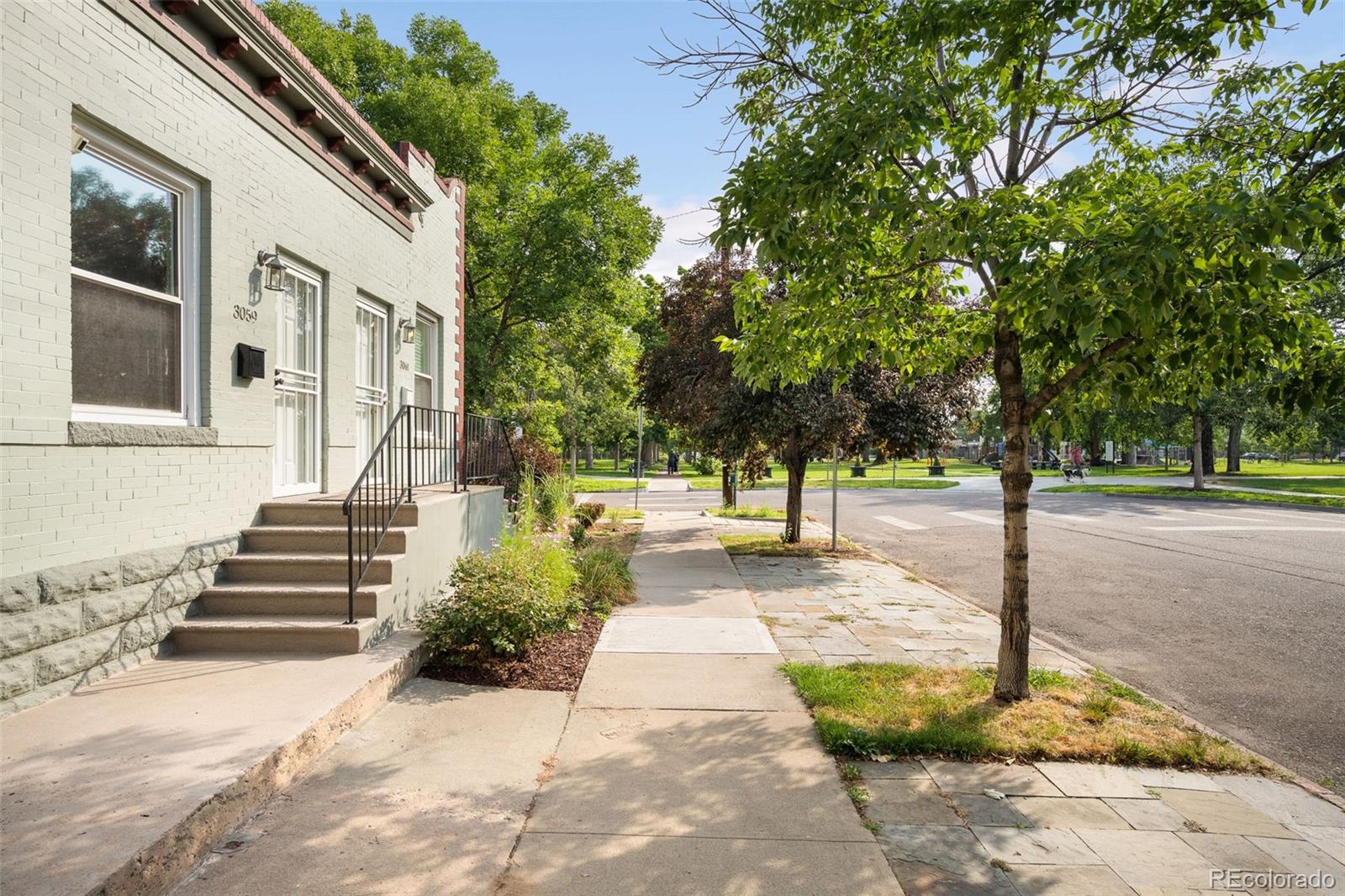 3059 Curtis Street Denver, CO 80205 - Photo 16 of 23 a view of a street with large trees