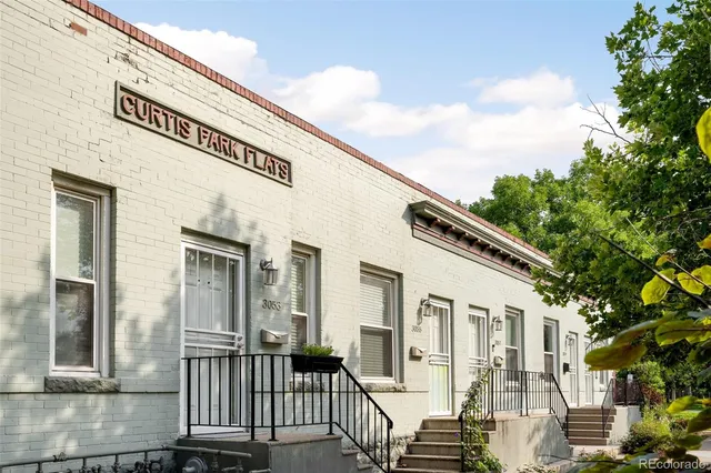 a view of a white house with many windows
