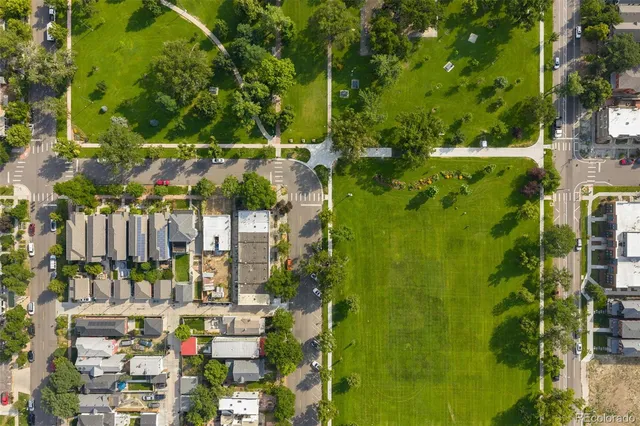 a front view of a house with a tree