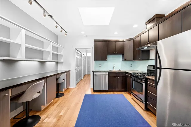 a kitchen with stainless steel appliances a refrigerator sink and microwave