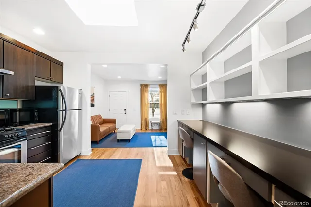 a kitchen with stainless steel appliances granite countertop a refrigerator and a stove top oven