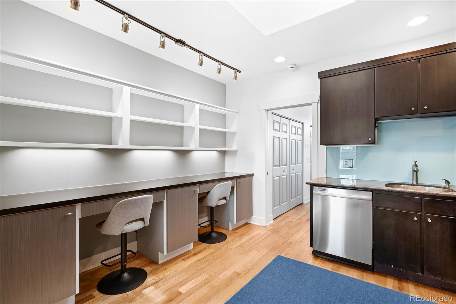 3059 Curtis Street Denver, CO 80205 - Photo 9 of 23 a kitchen with stainless steel appliances granite countertop a sink a stove and a wooden floors