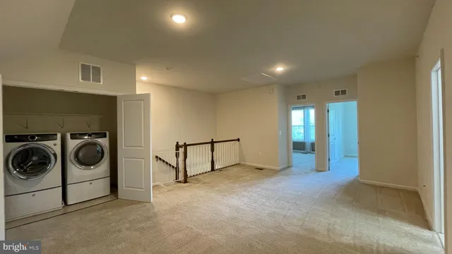 a view of a livingroom with washer and dryer