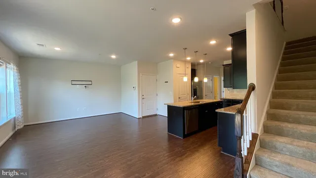 a view of kitchen with cabinets and wooden floor