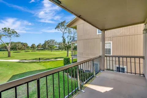 a view of balcony with outdoor space and yard