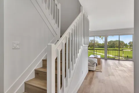 a view of a room with stairs and a floor to ceiling window