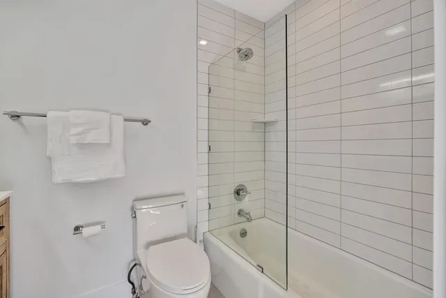 a bathroom with a toilet and bathtub