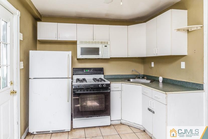 6 Mercury Road Edison, NJ 08817 - Photo 3 of 16 a kitchen with white cabinets and white appliances