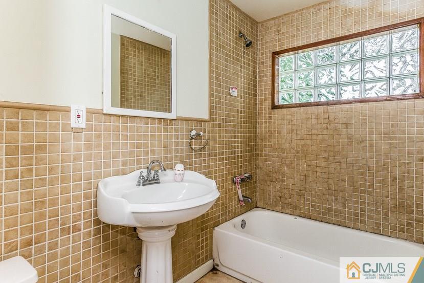 6 Mercury Road Edison, NJ 08817 - Photo 6 of 16 a bathroom with a sink a bathtub and window