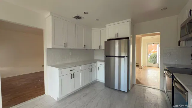 a kitchen with stainless steel appliances granite countertop a refrigerator and a stove