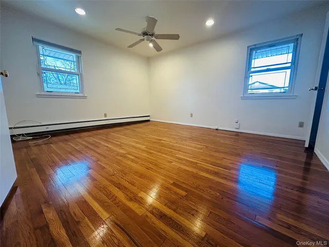 a view of a room with wooden floor and window