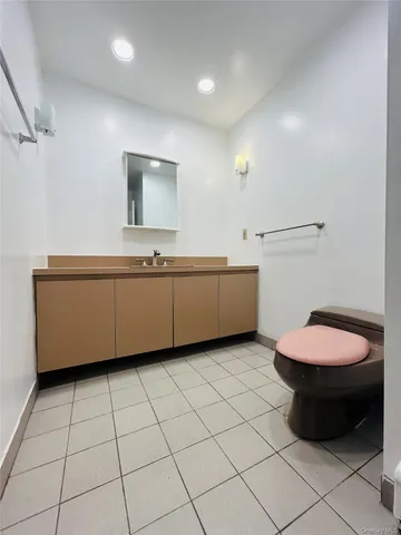a bathroom with a sink a toilet and mirror