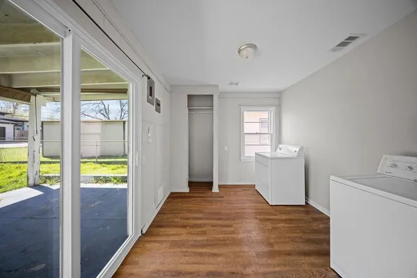 a view of an entryway with wooden floor and a sink