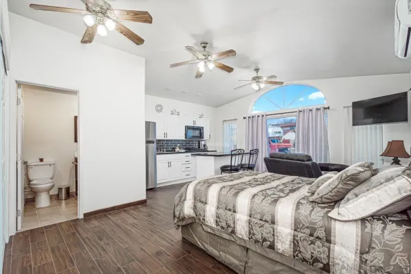 a bedroom with a bed and a chandelier