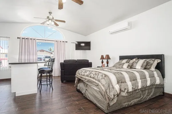 a bedroom with a bed and wooden floor