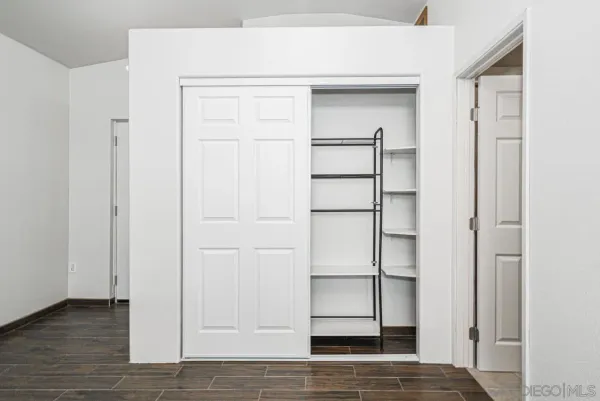 a view of walk in closet with empty racks