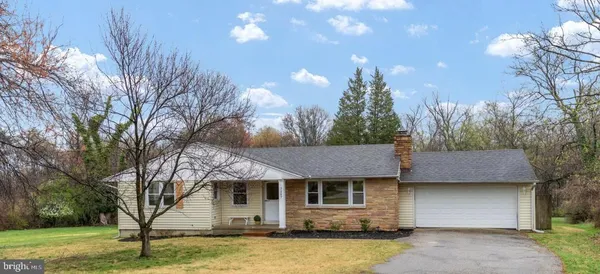 a view of a house with a yard and tree s
