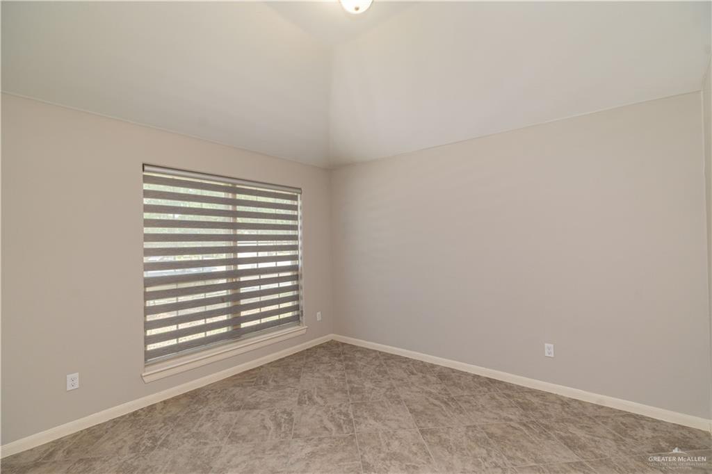412 South Paseo Del Rey Street Mission, TX 78572 - Photo 13 of 15 Spare room with lofted ceiling and baseboards