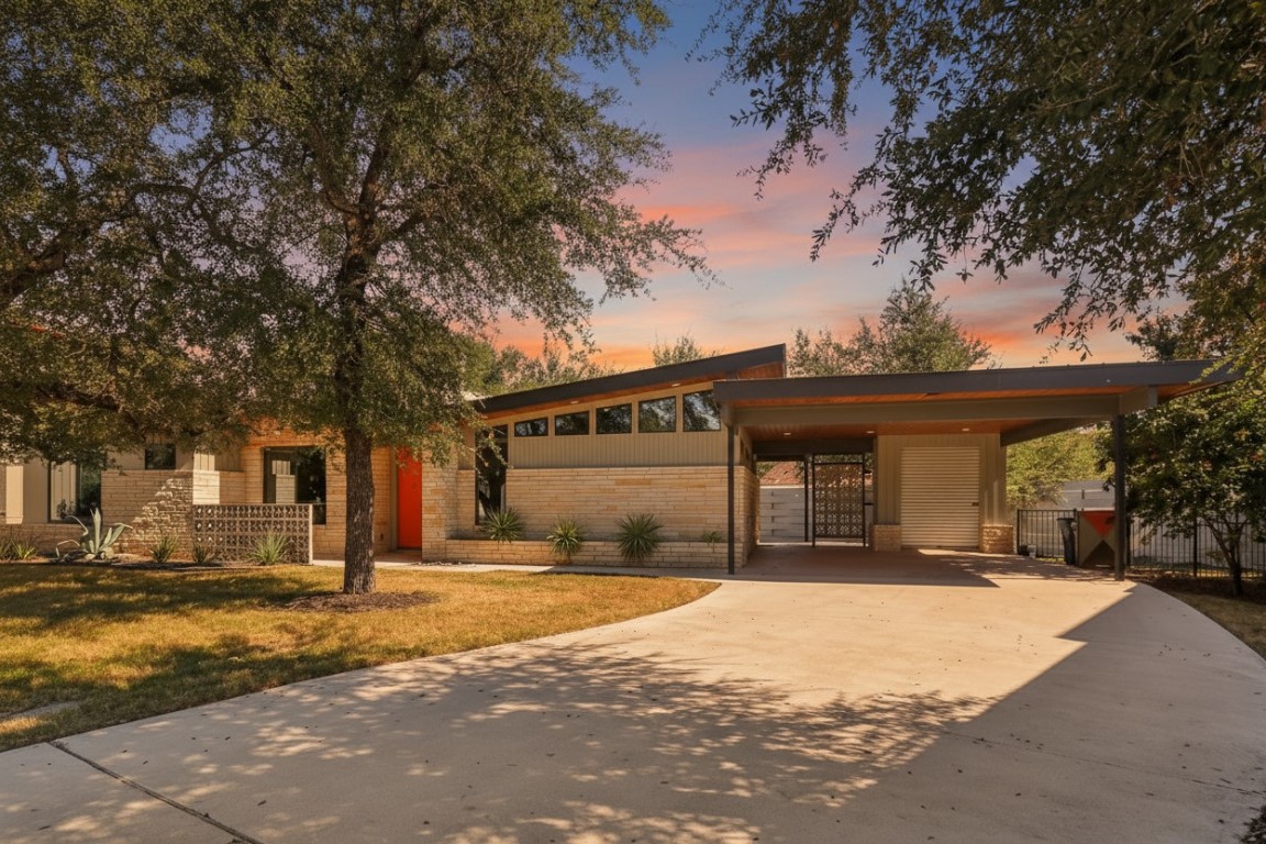 Welcome to this stunning single-story mid-century modern home in Starlight Village, featuring a striking angled roofline and natural stone accents.