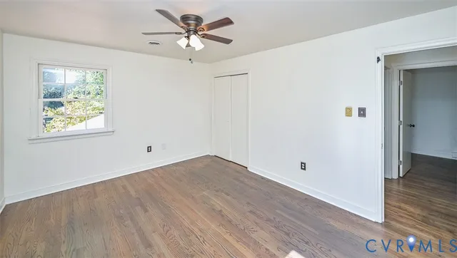 wooden floor in an empty room with a window