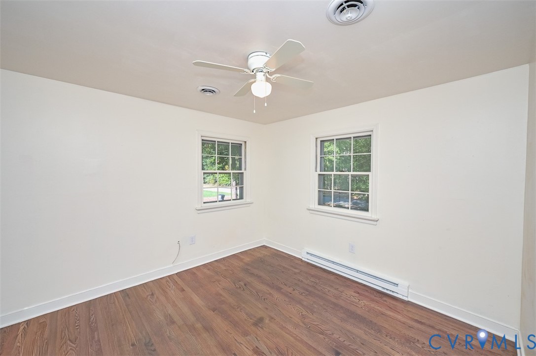11331 Winterpock Road Chesterfield, VA 23838 - Photo 21 of 49 an empty room with wooden floor fan and windows