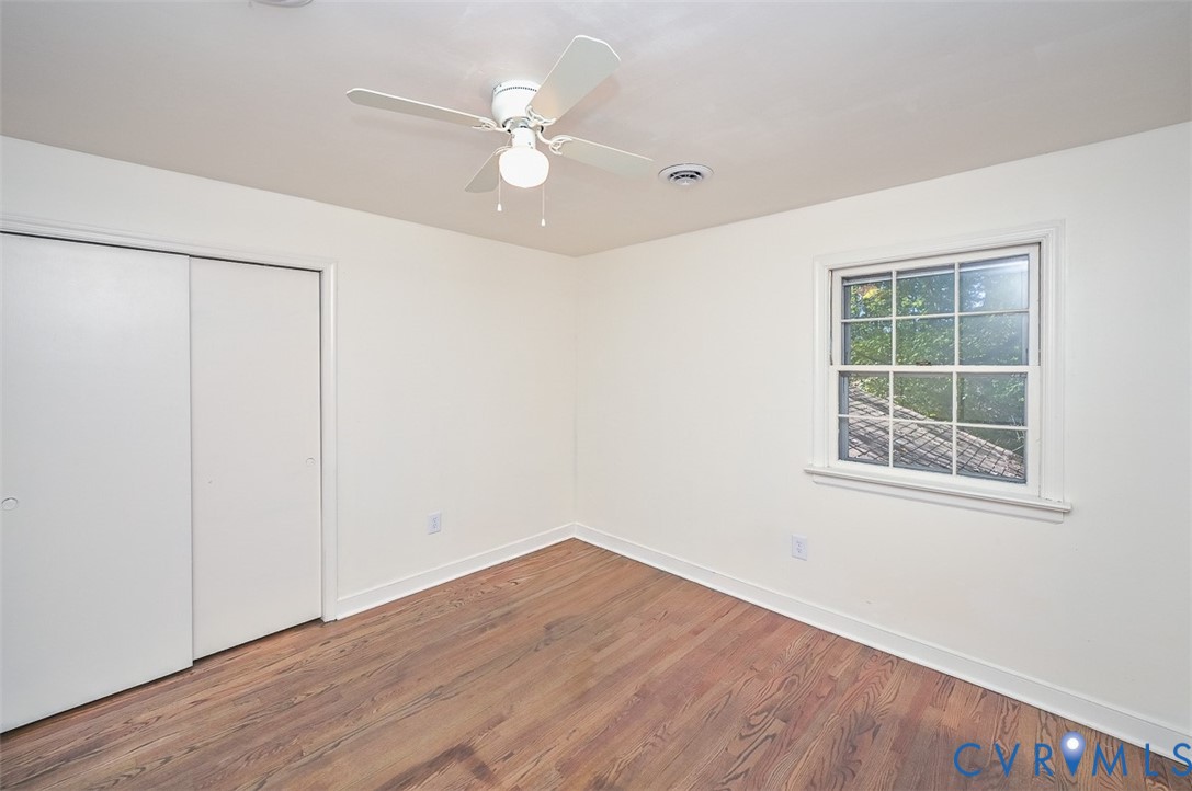 11331 Winterpock Road Chesterfield, VA 23838 - Photo 22 of 49 an empty room with wooden floor fan and windows