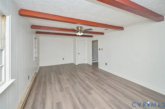 a view of a room with wooden floor