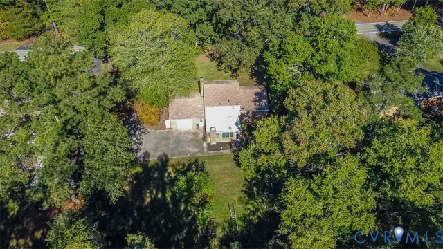 an aerial view of a house with a yard