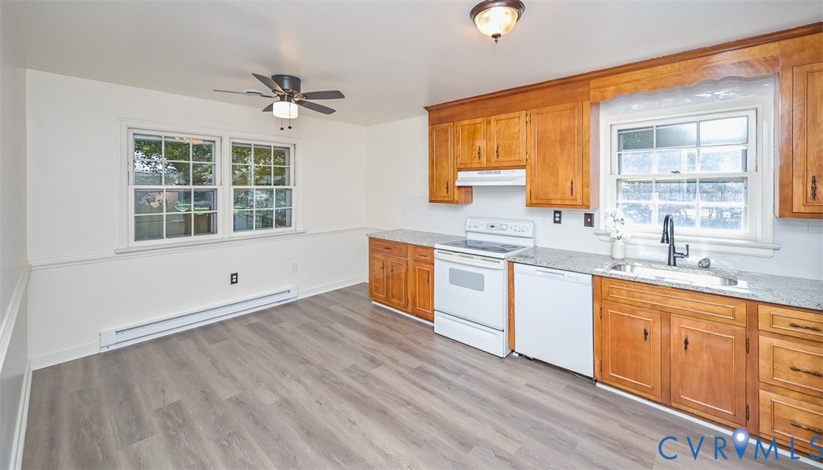 11331 Winterpock Road Chesterfield, VA 23838 - Photo 10 of 49 a kitchen with stainless steel appliances granite countertop a sink cabinets and wooden floor