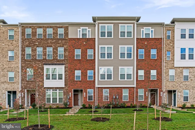 a front view of a building yard and trees
