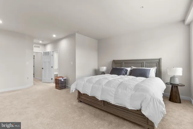 a bedroom with a bed and a night stand