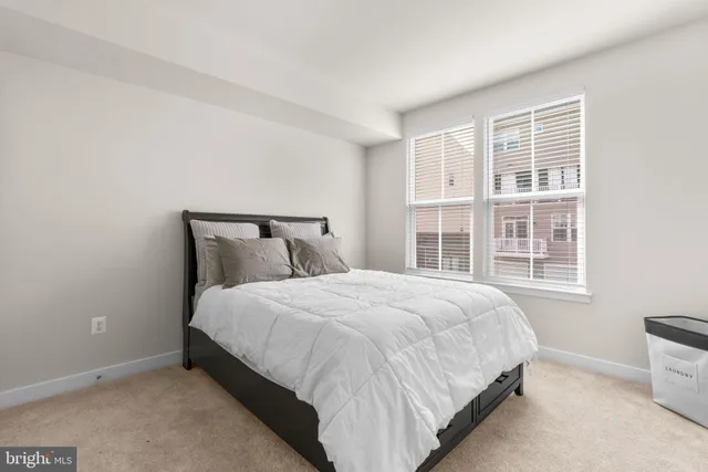 a large bed sitting in a bedroom next to a window