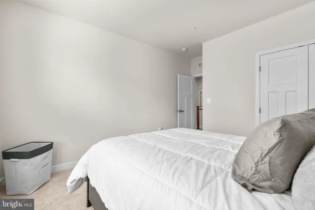 a bedroom with a bed and a couch