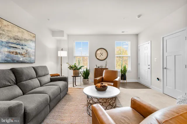 a living room with furniture and a clock