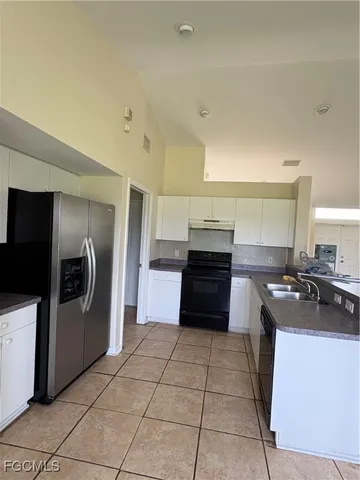 a kitchen with stainless steel appliances a stove a sink and a refrigerator