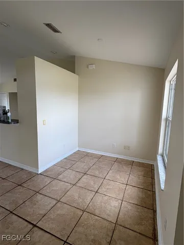a view of an empty room and a window