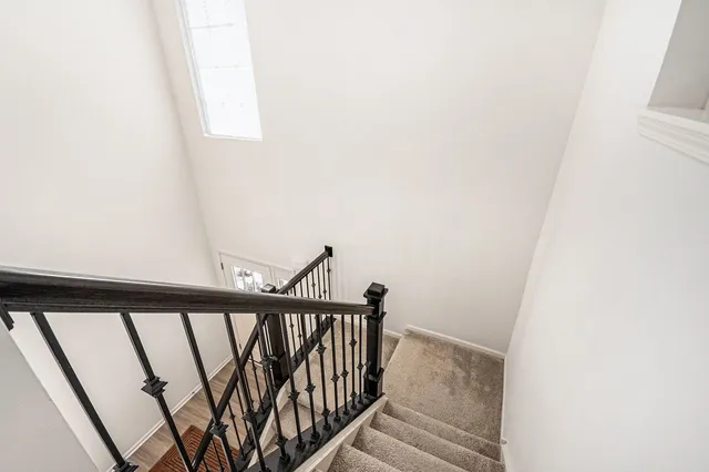 a view of staircase with rug