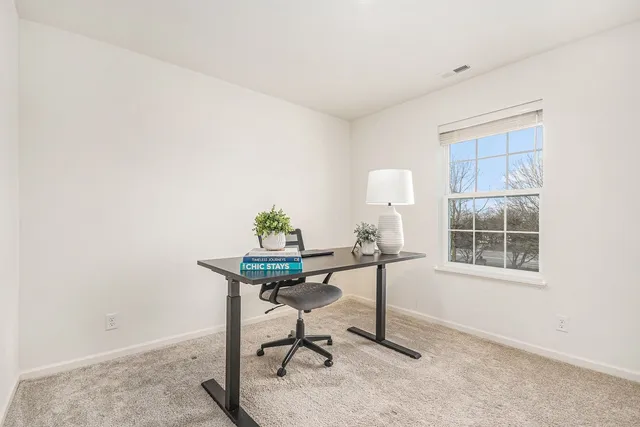 a workspace with furniture and window