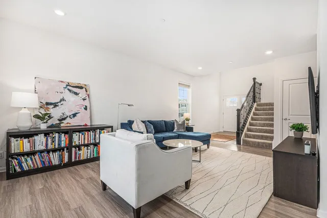 a living room with furniture and wooden floor