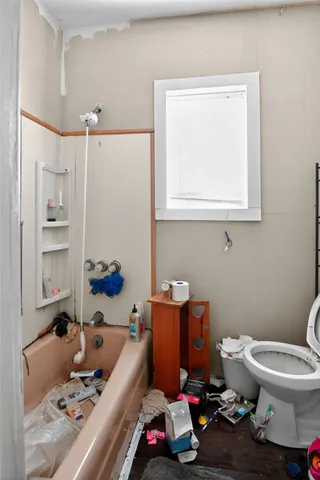 a room with furniture a rug and a window