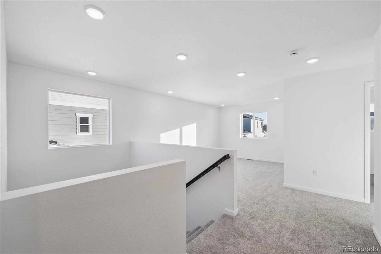 5594 Brangus Drive Windsor, CO 80528 - Photo 11 of 22 an empty room with a entryway and stairs