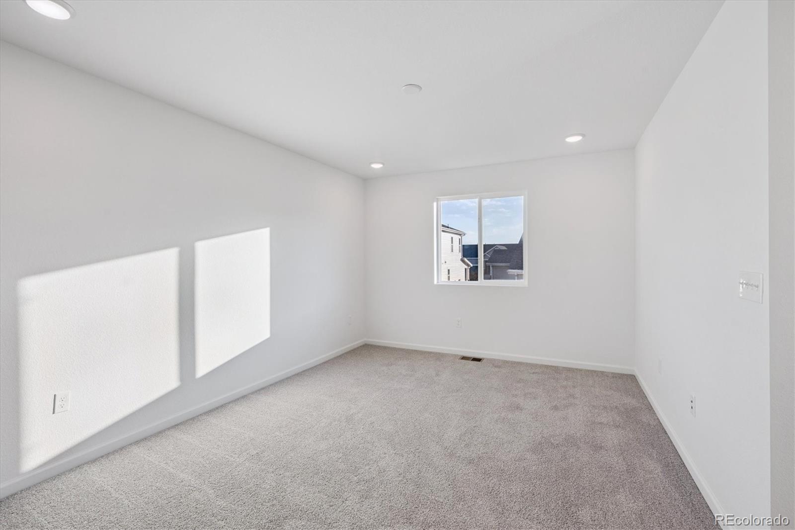 5594 Brangus Drive Windsor, CO 80528 - Photo 12 of 22 an empty room with a window