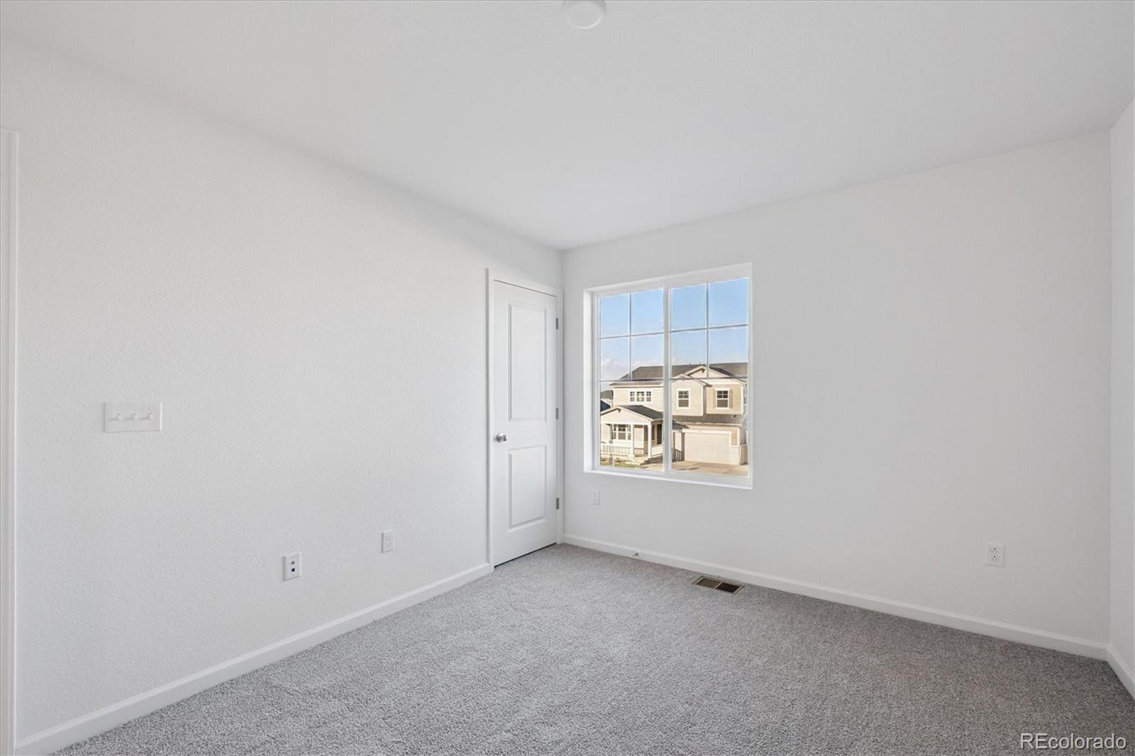 5594 Brangus Drive Windsor, CO 80528 - Photo 13 of 22 a view of an empty room and window