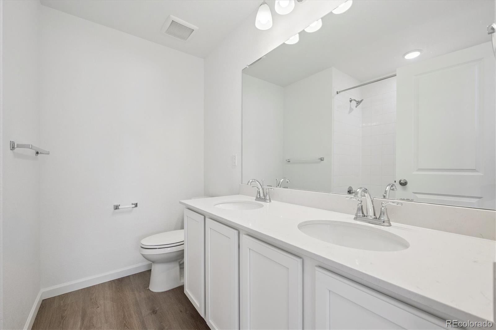 5594 Brangus Drive Windsor, CO 80528 - Photo 14 of 22 a bathroom with a toilet sink and mirror