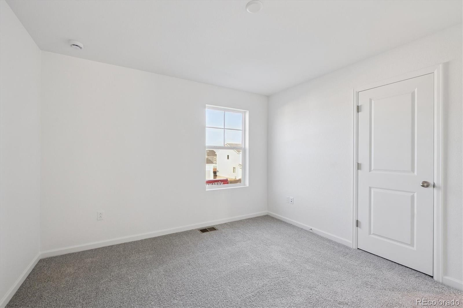 5594 Brangus Drive Windsor, CO 80528 - Photo 15 of 22 a view of an empty room with a window